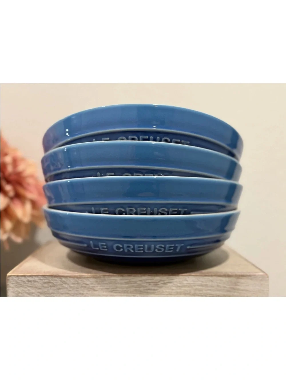 The product is a set of 4 Le Creuset deep round dish plates in a striking azure
